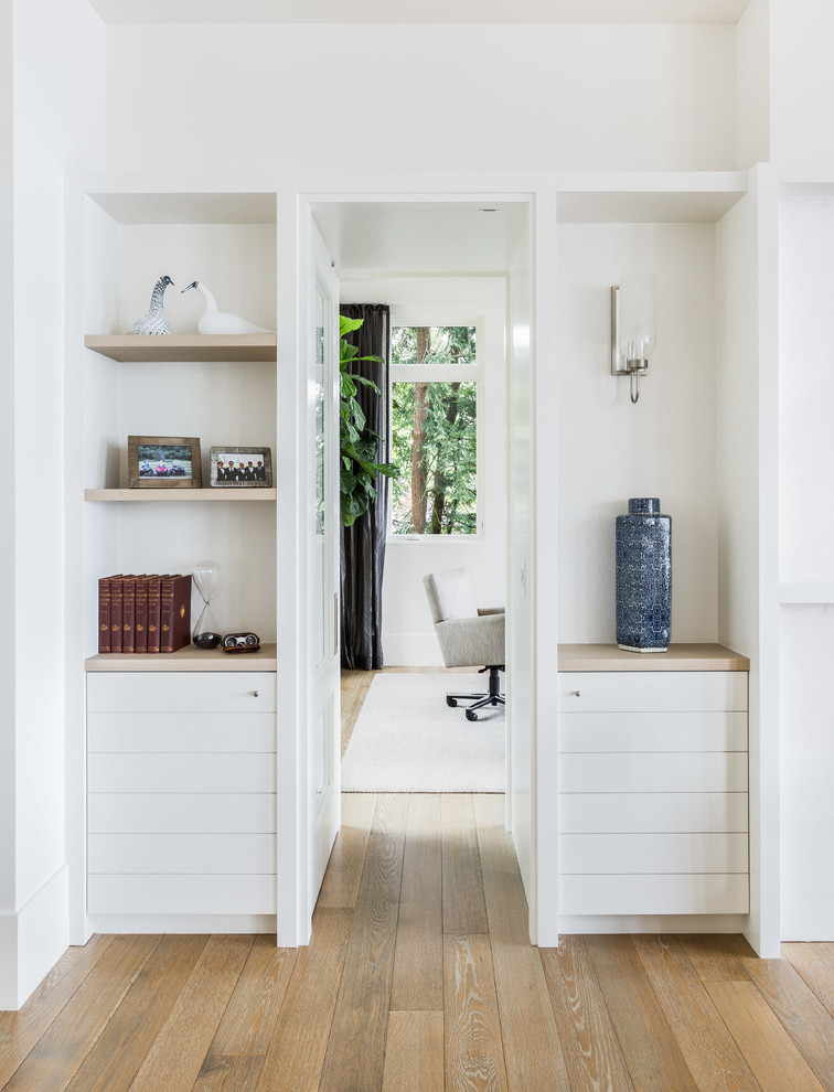 Inspiration for a mid-sized contemporary light wood floor hallway remodel in Seattle with white walls