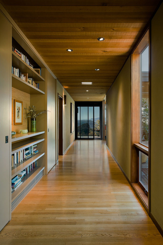 Hallway - large contemporary medium tone wood floor and beige floor hallway idea in San Francisco with beige walls