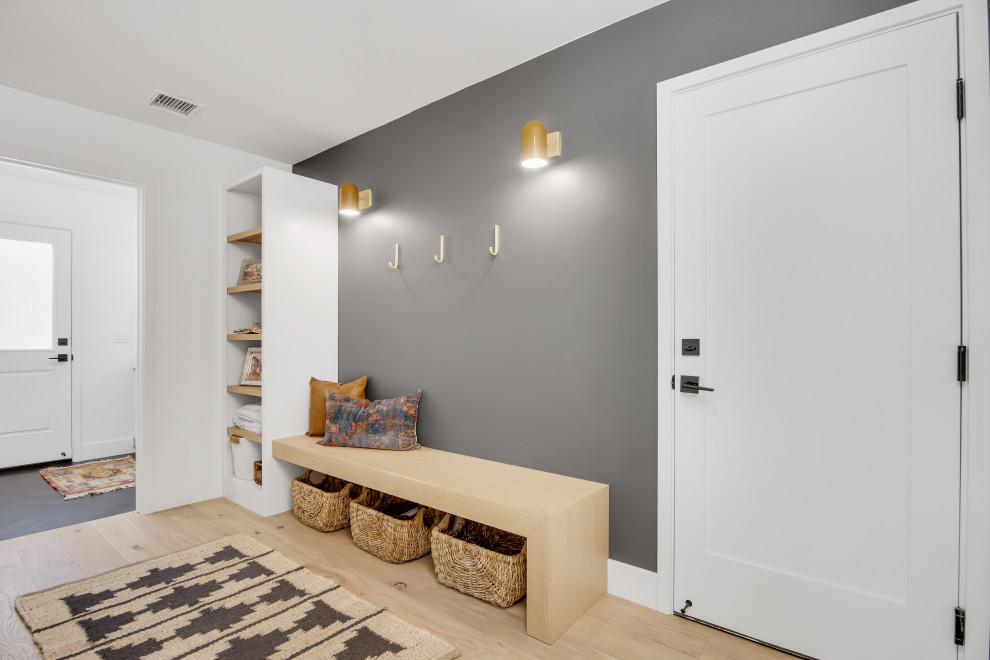 Example of a mid-sized beach style light wood floor and beige floor hallway design in Orange County with gray walls