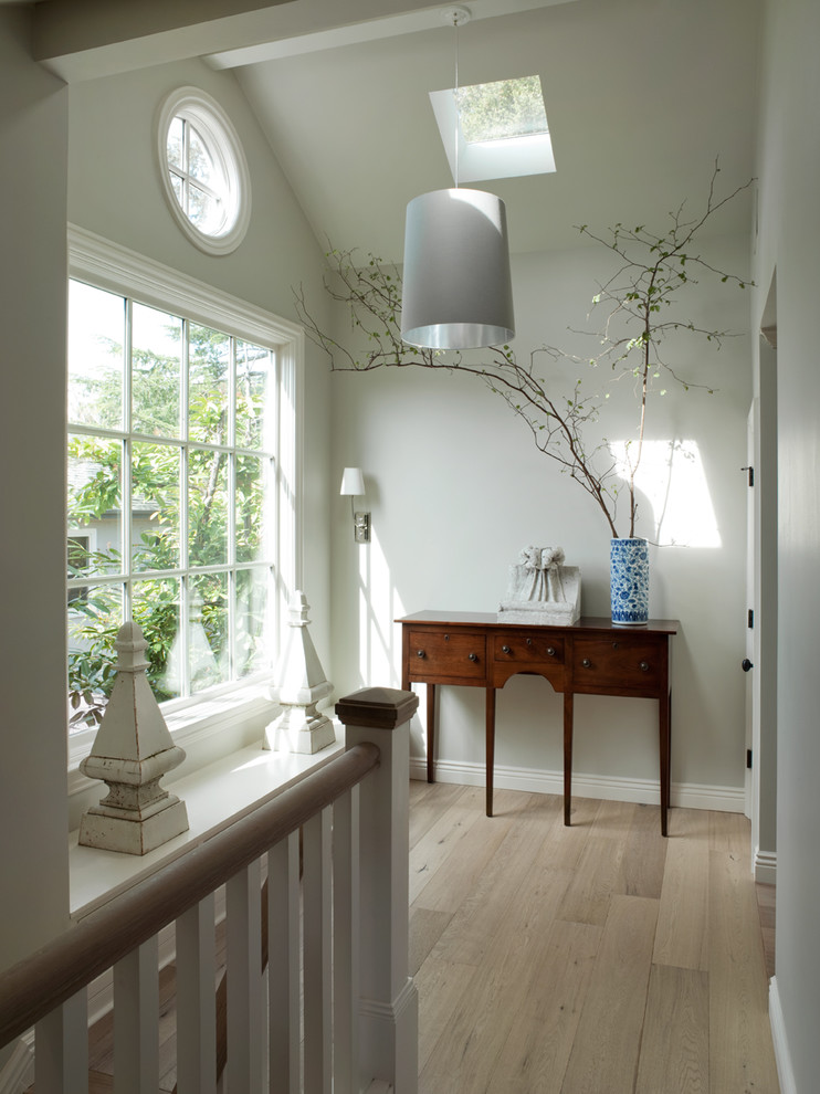 Example of a classic light wood floor and beige floor hallway design in San Francisco with white walls