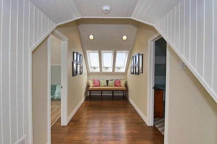 Example of a mid-sized transitional medium tone wood floor hallway design in Salt Lake City with multicolored walls