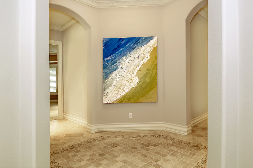 Inspiration for a huge timeless travertine floor and beige floor hallway remodel in Tampa with beige walls