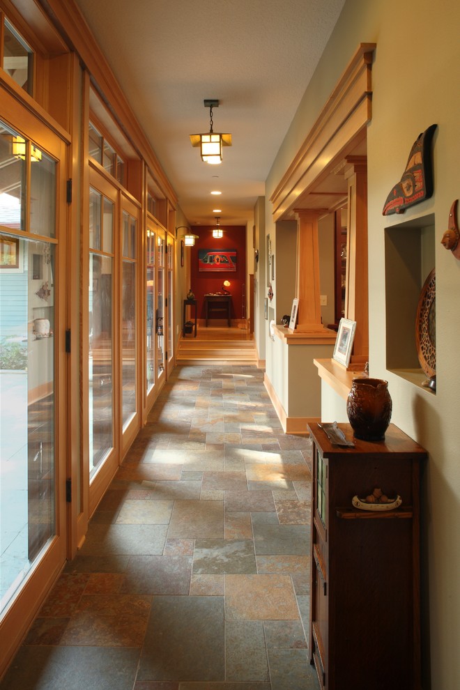 Hallway - large craftsman slate floor hallway idea in Portland with green walls