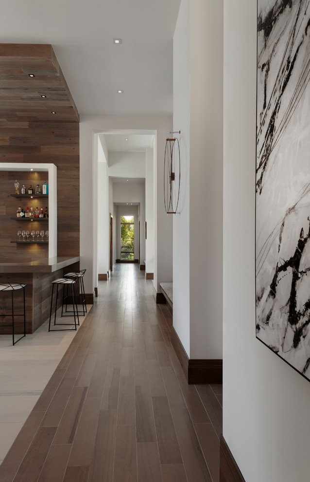 Свежая идея для дизайна: большой коридор в стиле модернизм с белыми стенами, темным паркетным полом и коричневым полом - отличное фото интерьера