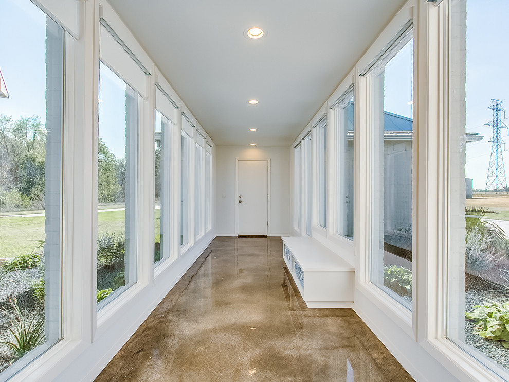 Example of a large trendy concrete floor hallway design in Oklahoma City with gray walls