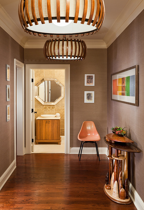 Mid-sized eclectic medium tone wood floor and brown floor hallway photo in New York with beige walls