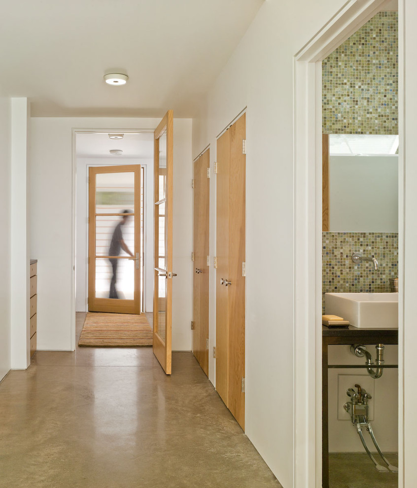 Mid-sized cottage concrete floor and beige floor hallway photo in Burlington with white walls
