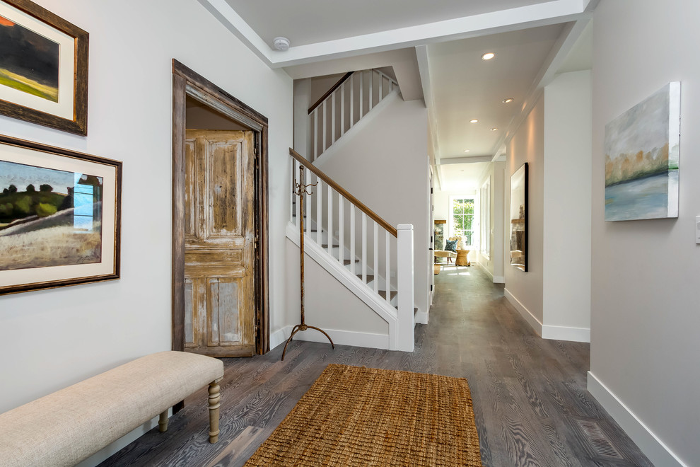 Example of a mid-sized medium tone wood floor hallway design in Seattle with gray walls