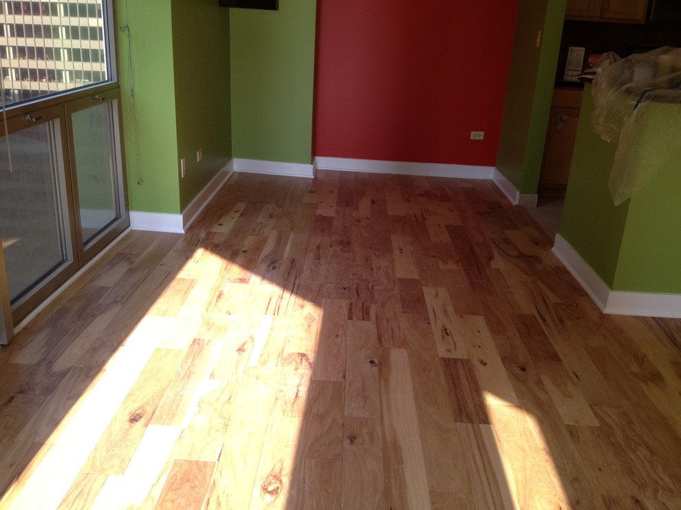 Example of a mid-sized minimalist light wood floor hallway design in Austin with multicolored walls
