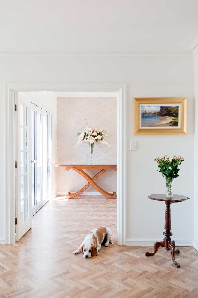 Inspiration for a large transitional medium tone wood floor hallway remodel in Perth with white walls