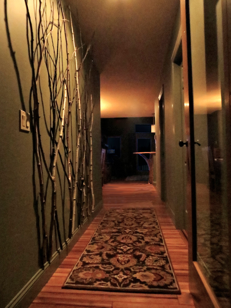 Hallway - small rustic bamboo floor hallway idea in Boston with green walls
