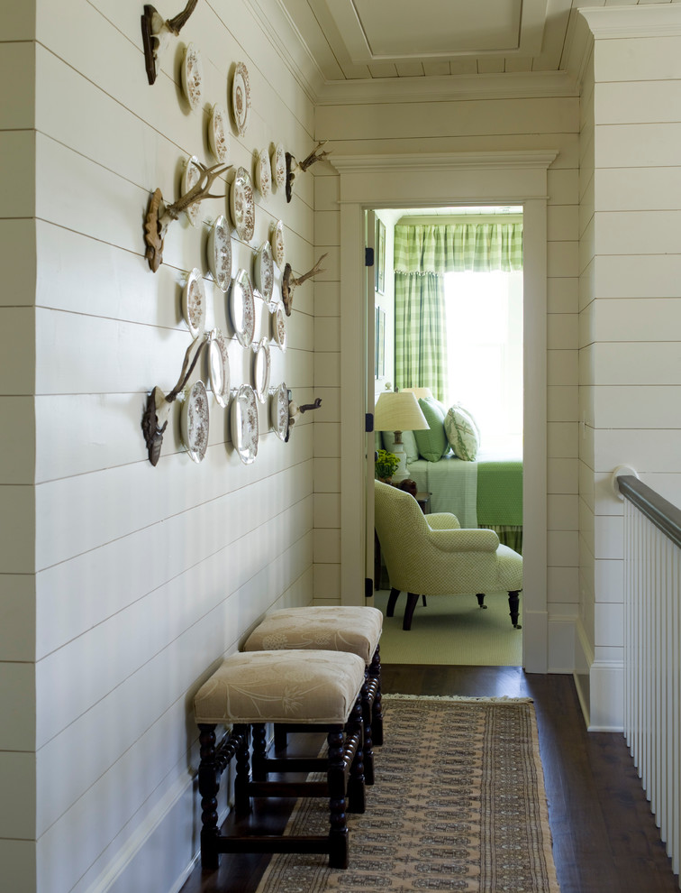 Large elegant dark wood floor hallway photo in Raleigh with white walls