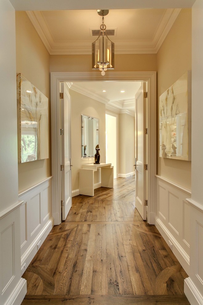 Идея дизайна: большой коридор в классическом стиле с бежевыми стенами, коричневым полом и паркетным полом среднего тона