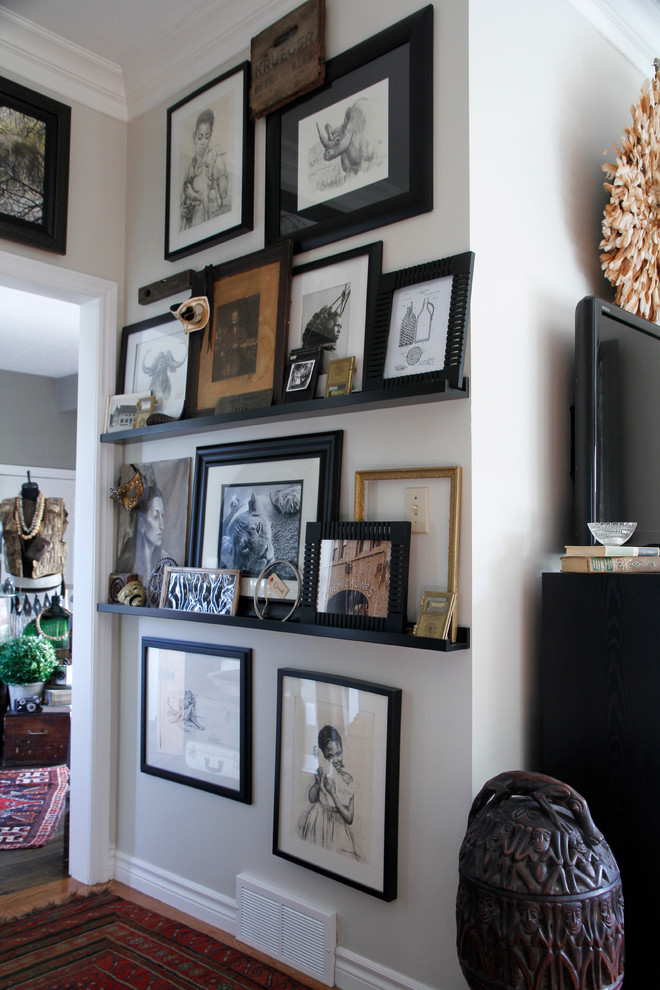 Inspiration for an eclectic medium tone wood floor hallway remodel in Toronto with white walls