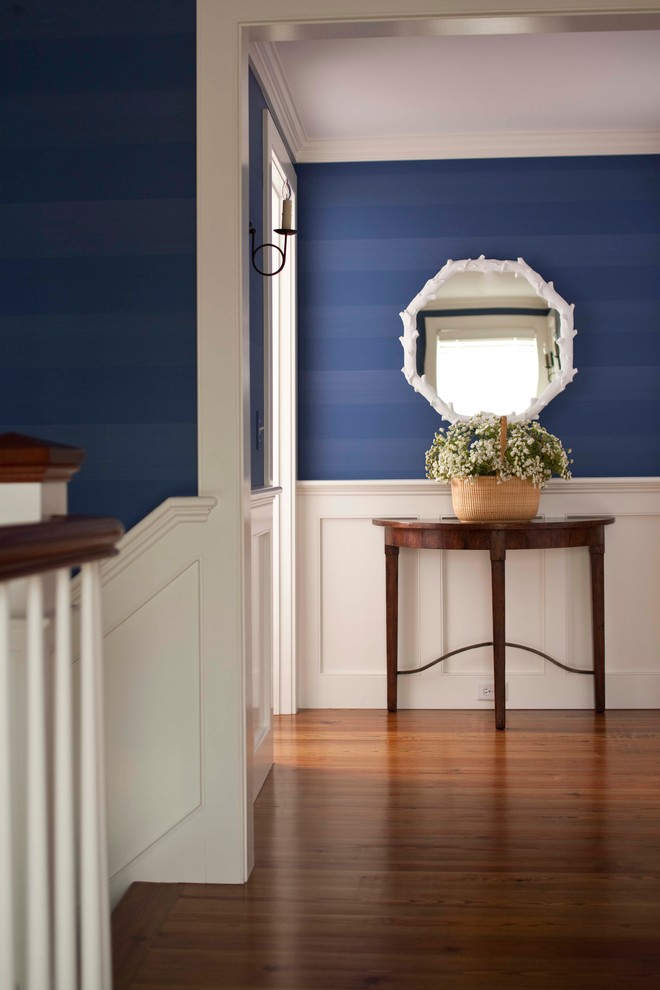 Inspiration for a mid-sized timeless dark wood floor hallway remodel in Boston with blue walls