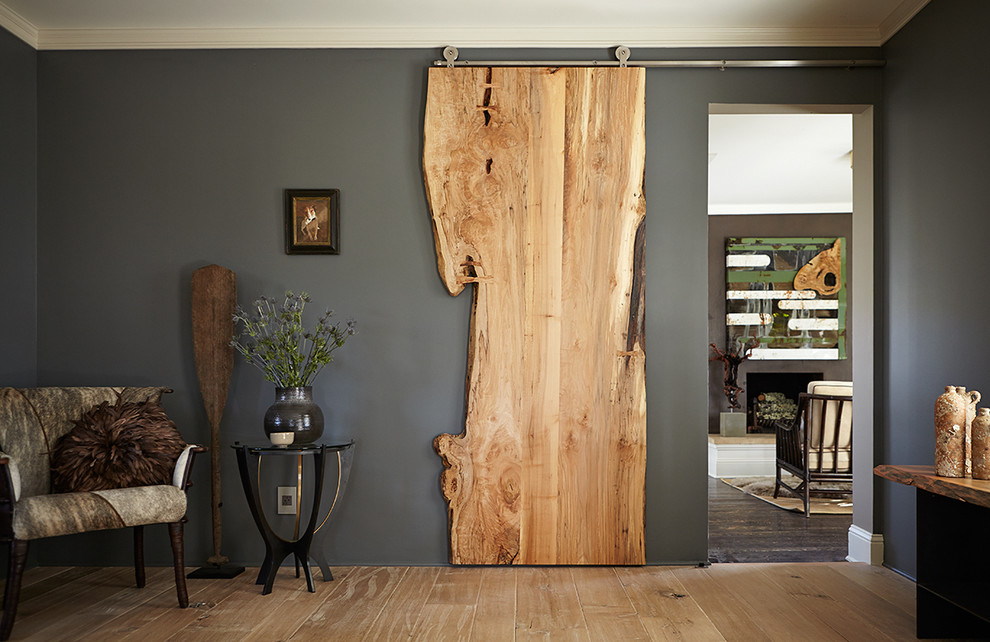 Transitional light wood floor hallway photo in New York with gray walls