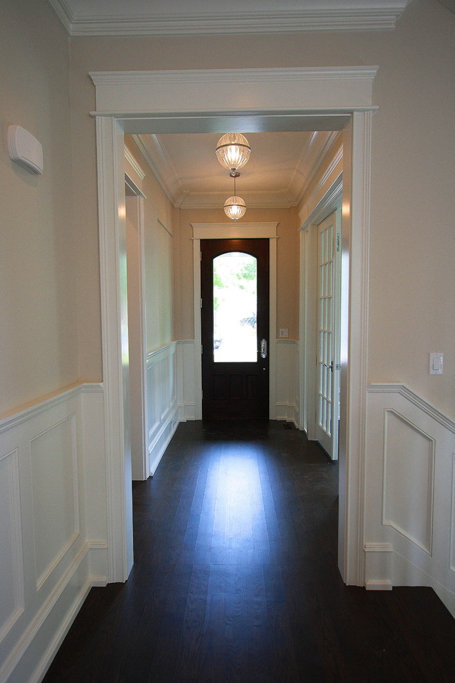 Hallway - dark wood floor hallway idea in Chicago with beige walls