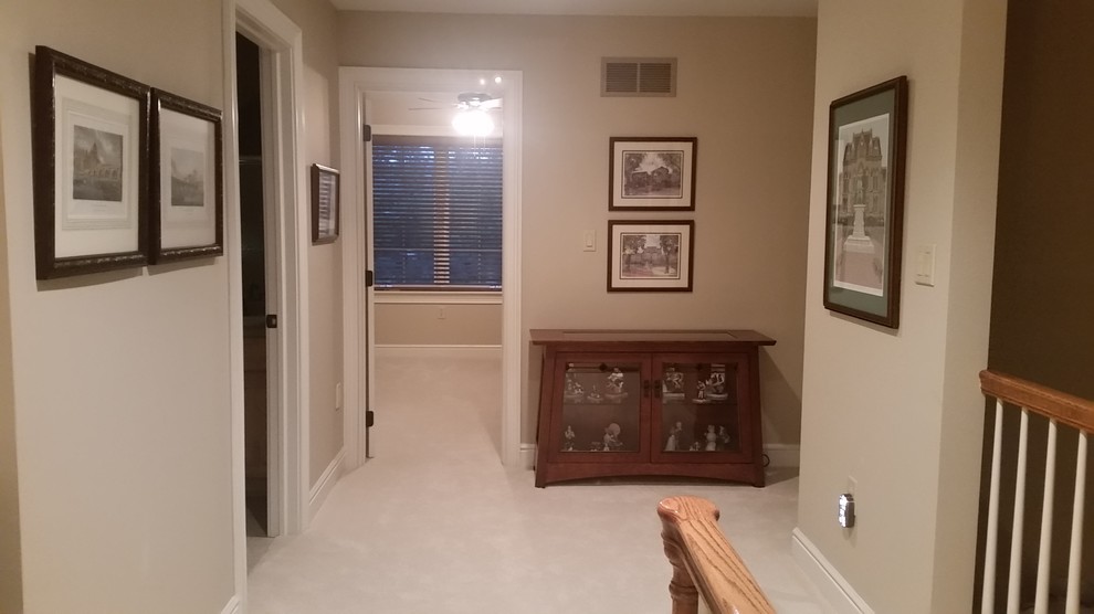 Example of a large classic carpeted hallway design in Other with beige walls