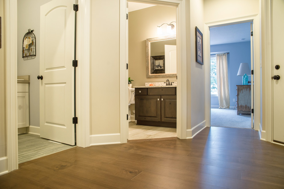Hallway - mid-sized coastal dark wood floor and brown floor hallway idea with beige walls