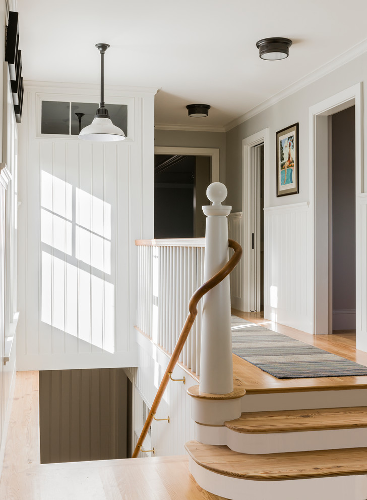 Inspiration for a coastal medium tone wood floor hallway remodel in Boston with gray walls