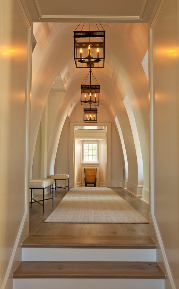 Inspiration for a mid-sized transitional medium tone wood floor and brown floor hallway remodel in Charlotte with white walls