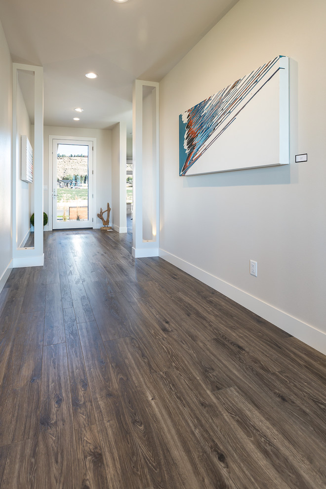 Hallway - large transitional laminate floor and brown floor hallway idea in Other with gray walls