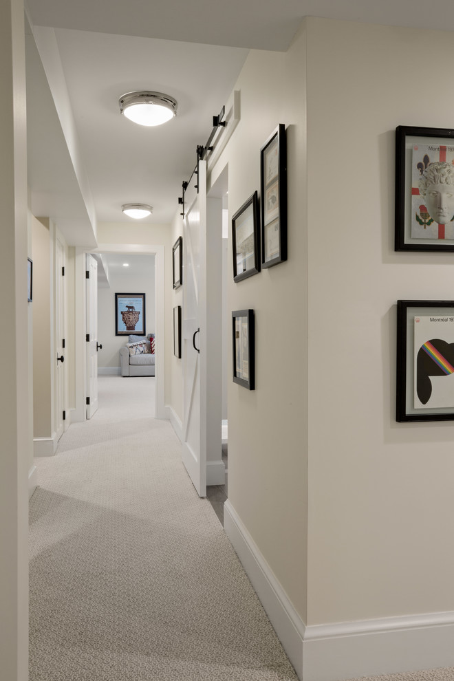 Mid-sized country carpeted and beige floor hallway photo in Burlington with beige walls