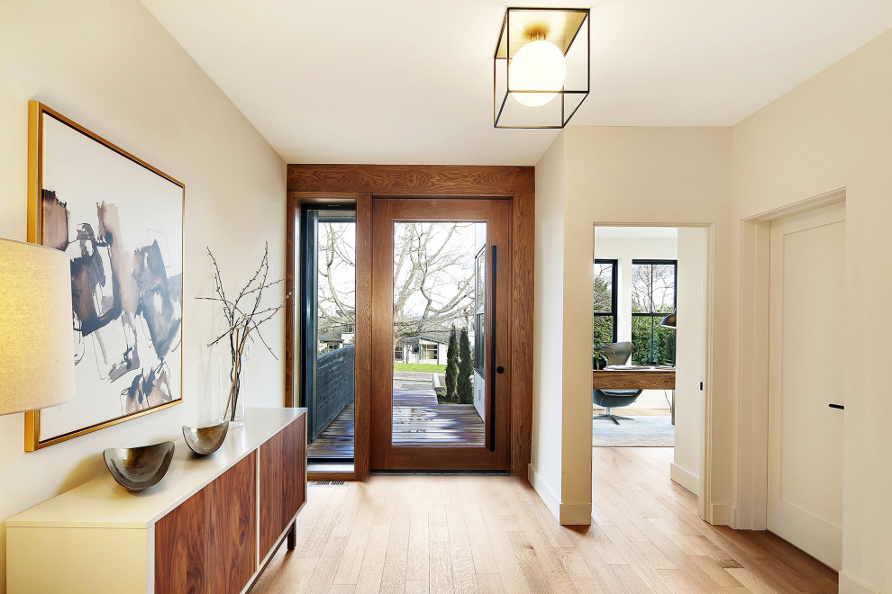 Example of a large danish medium tone wood floor and brown floor hallway design in Seattle with white walls