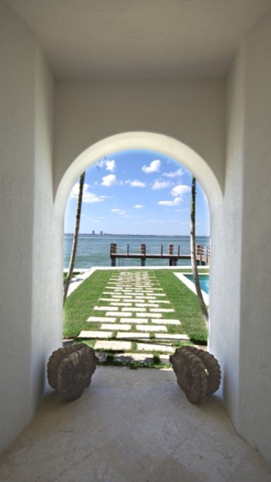 Inspiration for a mid-sized mediterranean beige floor hallway remodel in Miami with white walls