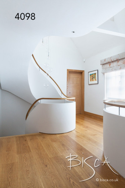 Example of a trendy medium tone wood floor hallway design in London with white walls