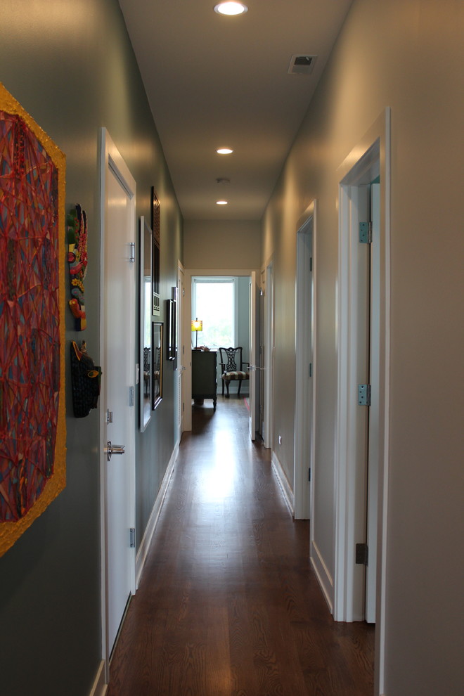 Hallway - mid-sized transitional medium tone wood floor hallway idea in Chicago with blue walls