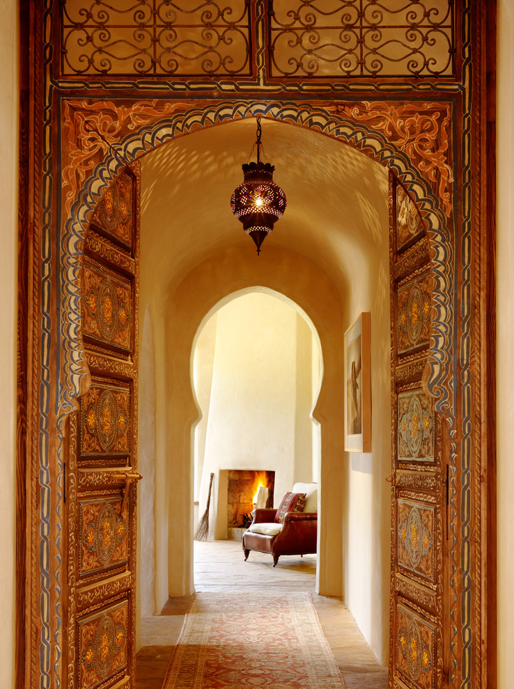 Example of a tuscan hallway design in Other with beige walls