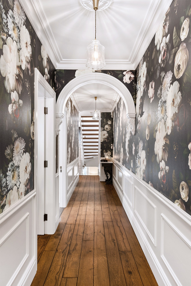 Inspiration for a transitional medium tone wood floor and brown floor hallway remodel in Sydney with black walls