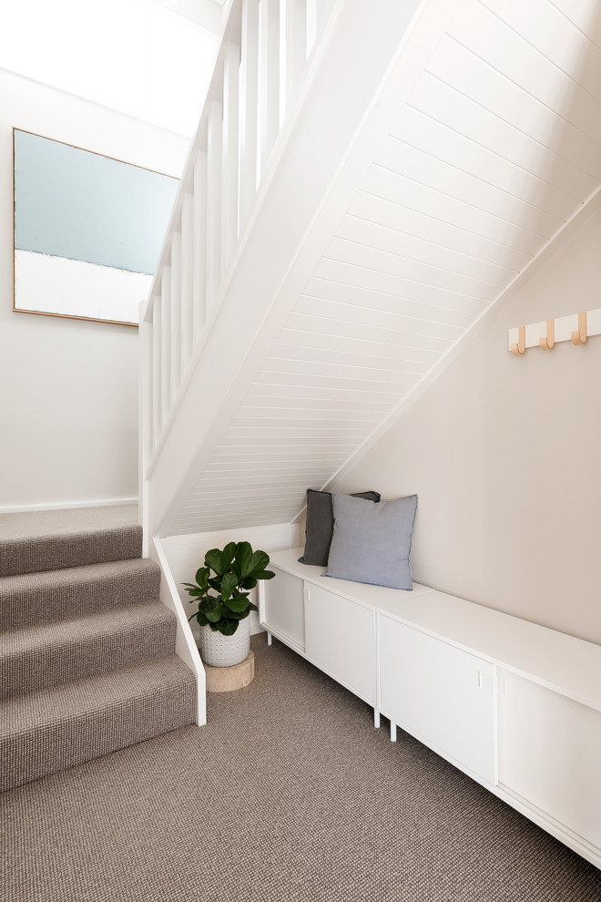 Example of a small beach style light wood floor hallway design in Sydney with white walls