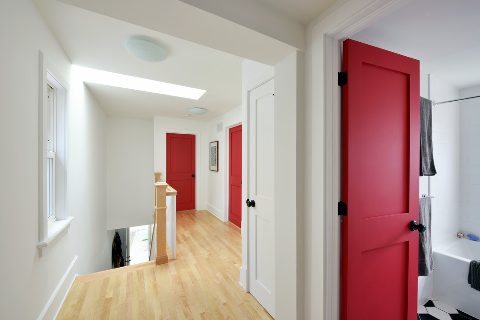 На фото: коридор среднего размера: освещение в стиле фьюжн с белыми стенами и светлым паркетным полом с