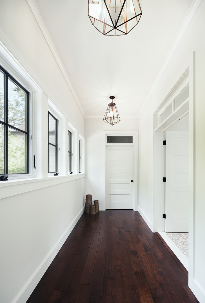 Hallway - scandinavian dark wood floor hallway idea in New York with white walls