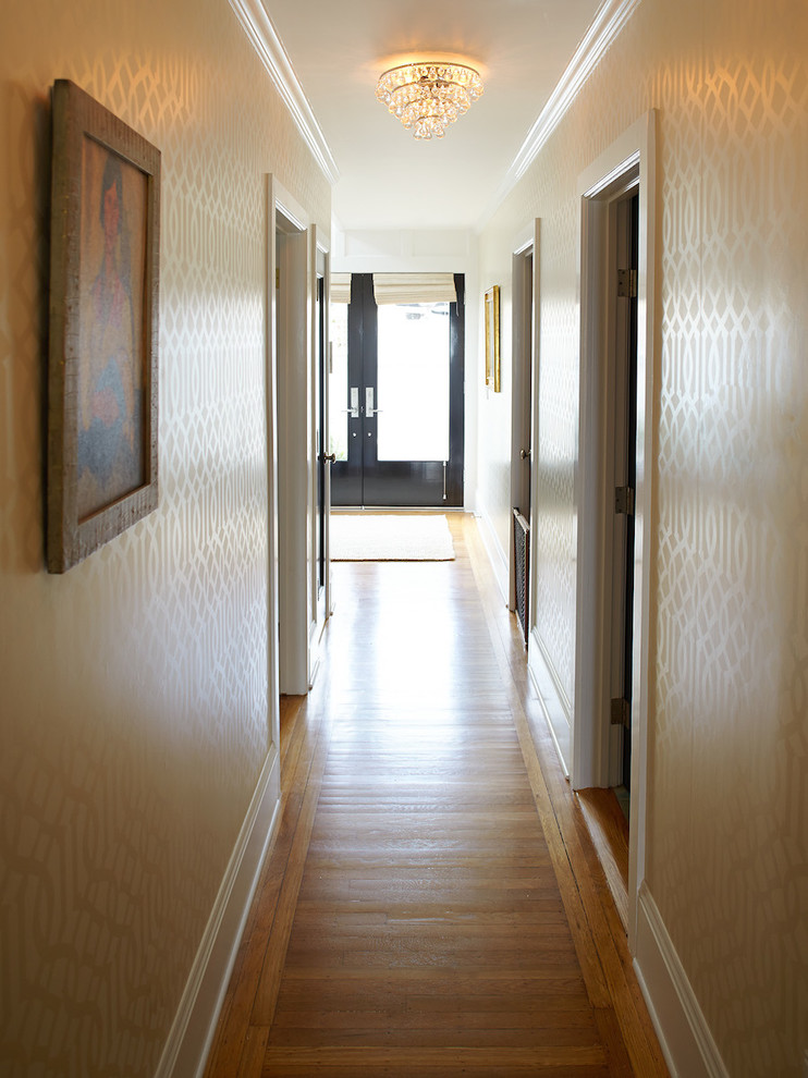 Mid-sized transitional medium tone wood floor hallway photo in San Francisco with beige walls