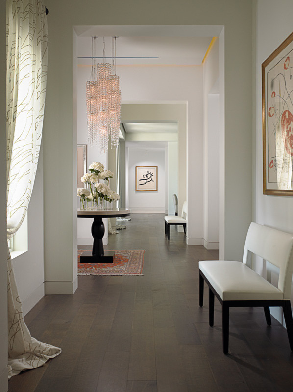 Inspiration for a large modern dark wood floor hallway remodel in Miami with white walls
