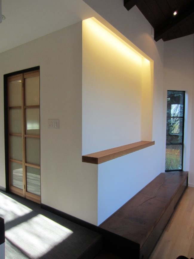 Example of a mid-sized zen dark wood floor hallway design in San Francisco with white walls