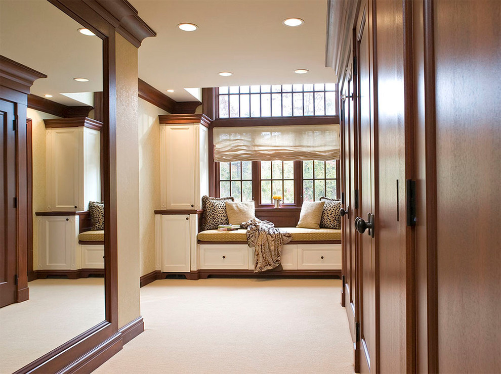 Example of a large classic carpeted and beige floor hallway design in New York with beige walls