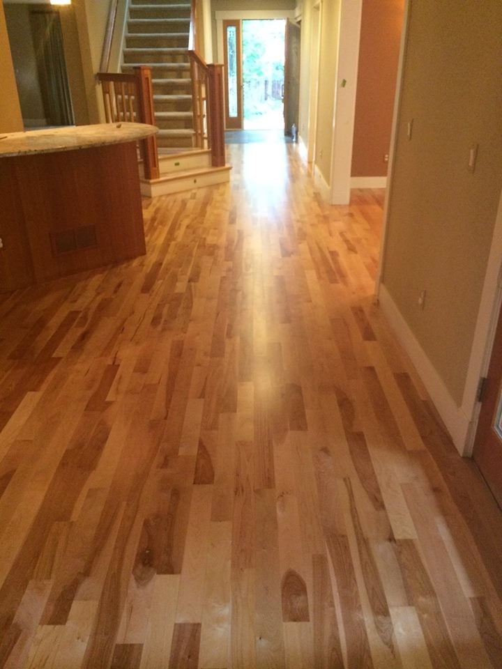 Example of a mid-sized classic light wood floor hallway design in Denver with beige walls