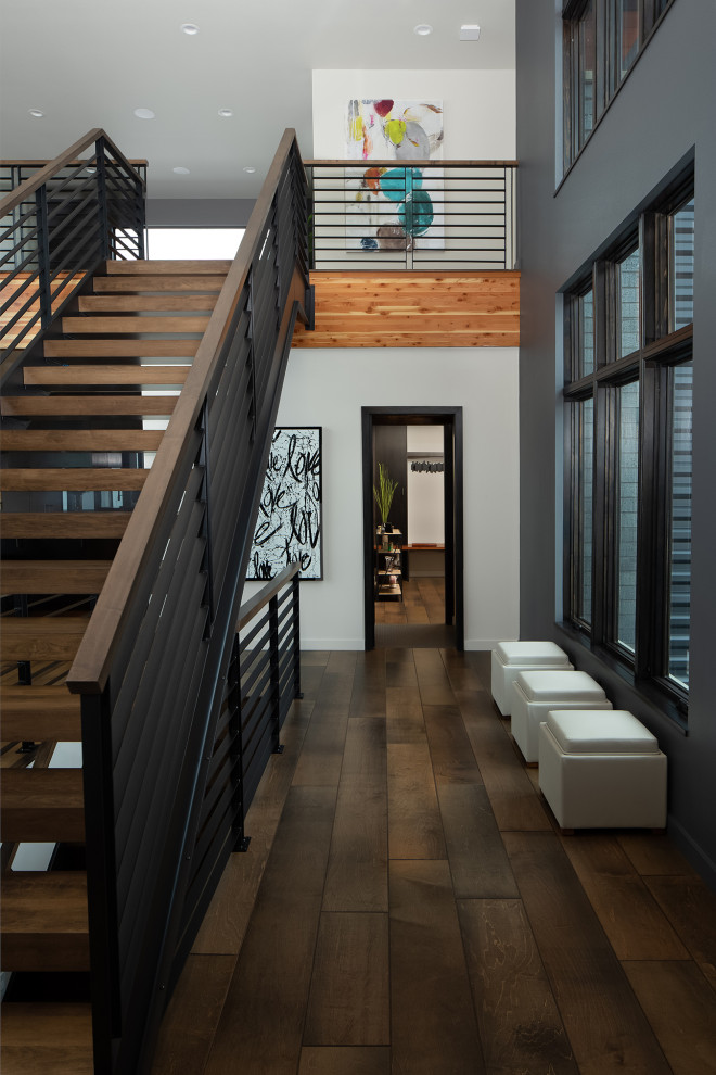 Großer Moderner Flur mit schwarzer Wandfarbe, braunem Holzboden und braunem Boden in Sonstige