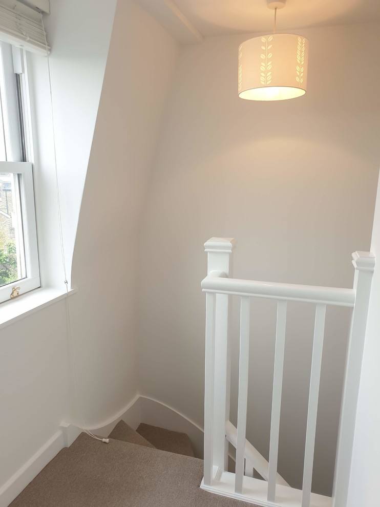 Inspiration for a mid-sized scandinavian carpeted, beige floor and tray ceiling hallway remodel in London with white walls