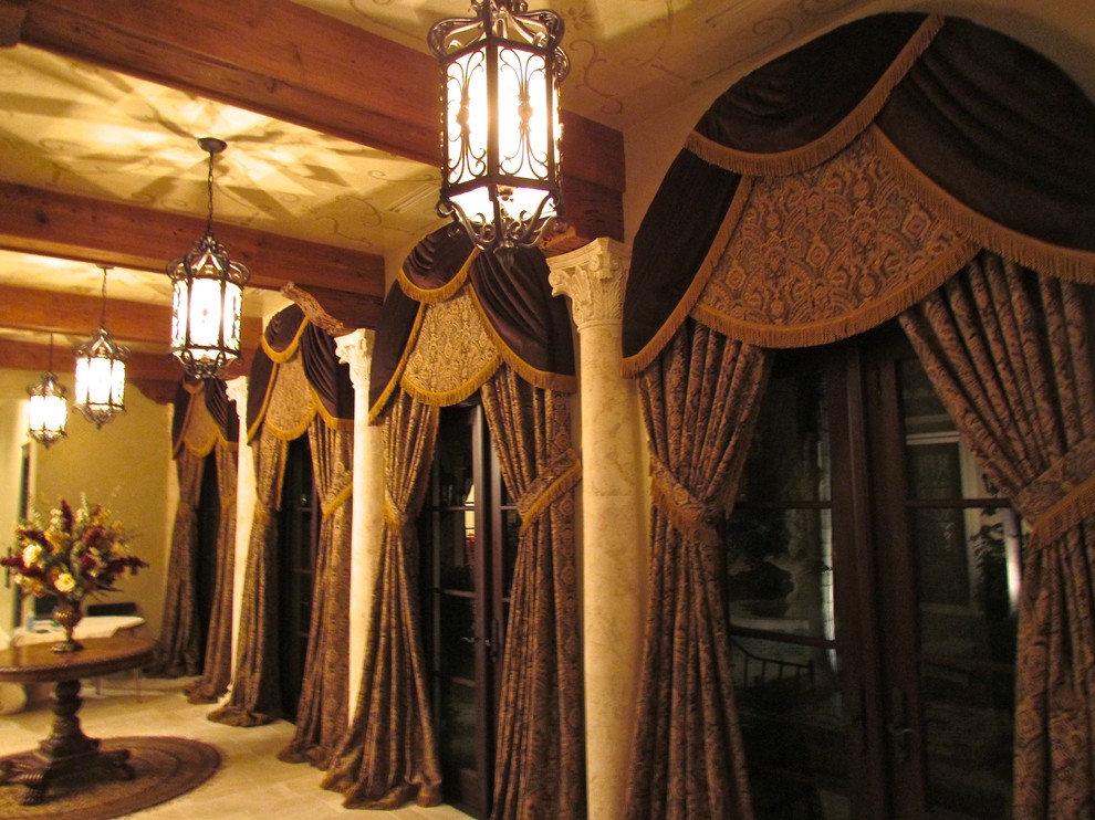 На фото: коридор в средиземноморском стиле с бежевыми стенами и полом из керамической плитки с