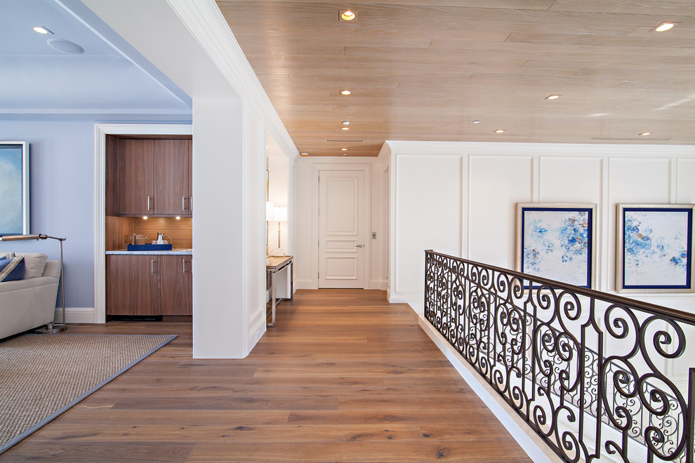 Inspiration for a huge transitional medium tone wood floor hallway remodel in Miami with white walls