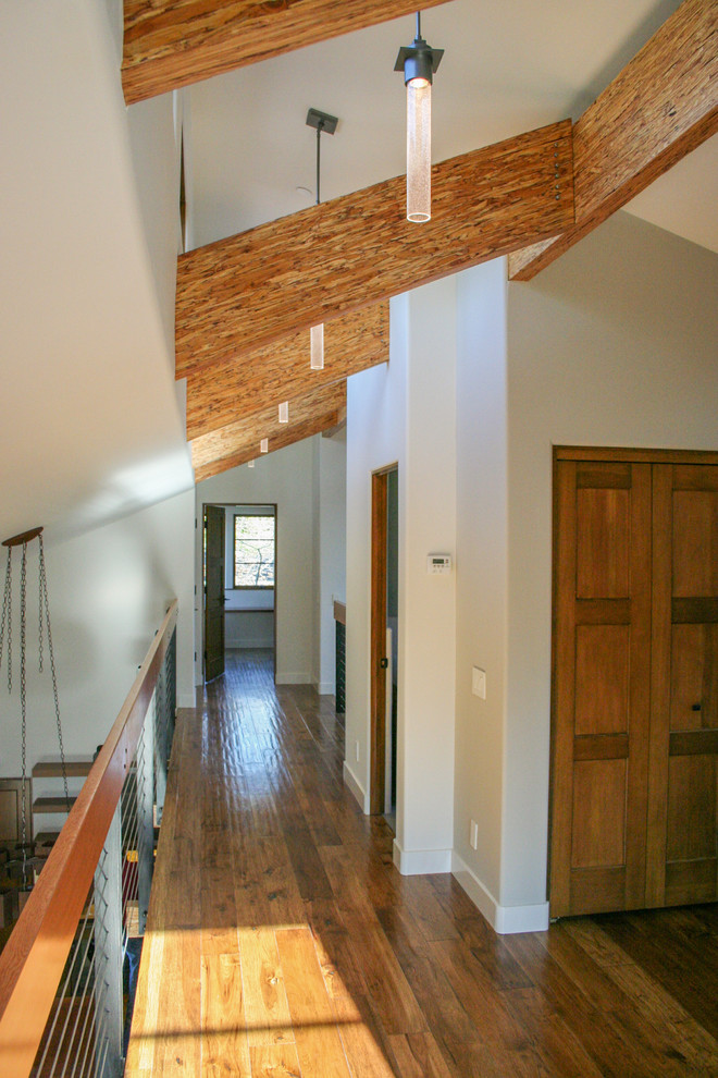 Inspiration for a mid-sized transitional medium tone wood floor hallway remodel in San Francisco with beige walls