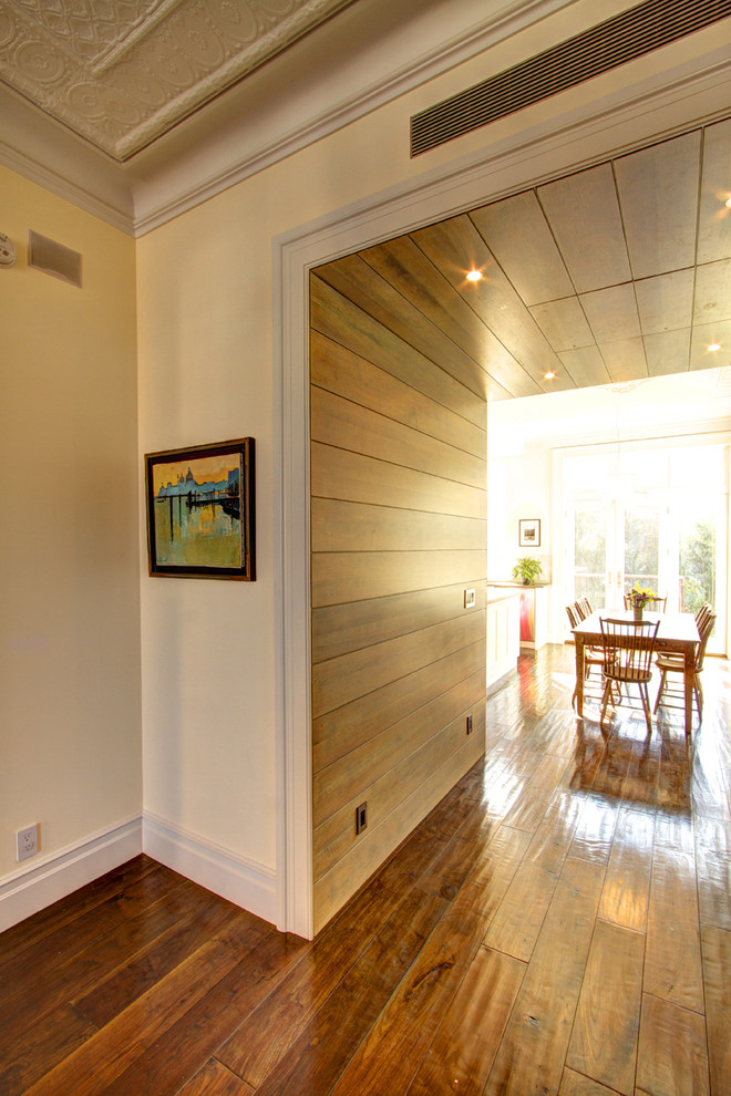 Example of a classic dark wood floor and brown floor hallway design in New York with beige walls