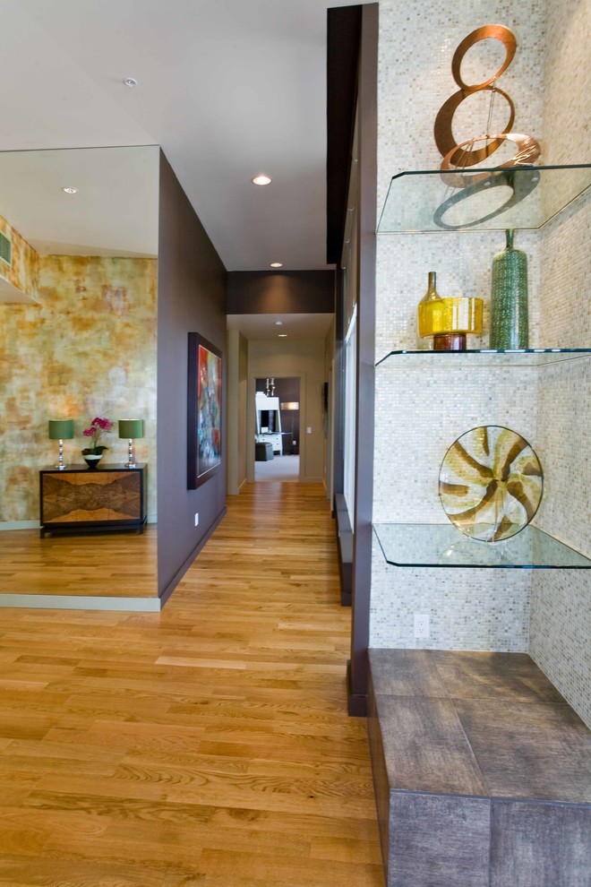 Example of a mid-sized trendy medium tone wood floor hallway design in Portland with brown walls