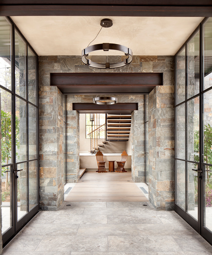 Inspiration for a huge contemporary ceramic tile and gray floor hallway remodel in Denver with gray walls