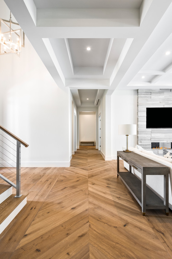 Large transitional medium tone wood floor and brown floor hallway photo in Miami with white walls